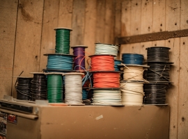 blue and green thread on brown wooden shelf