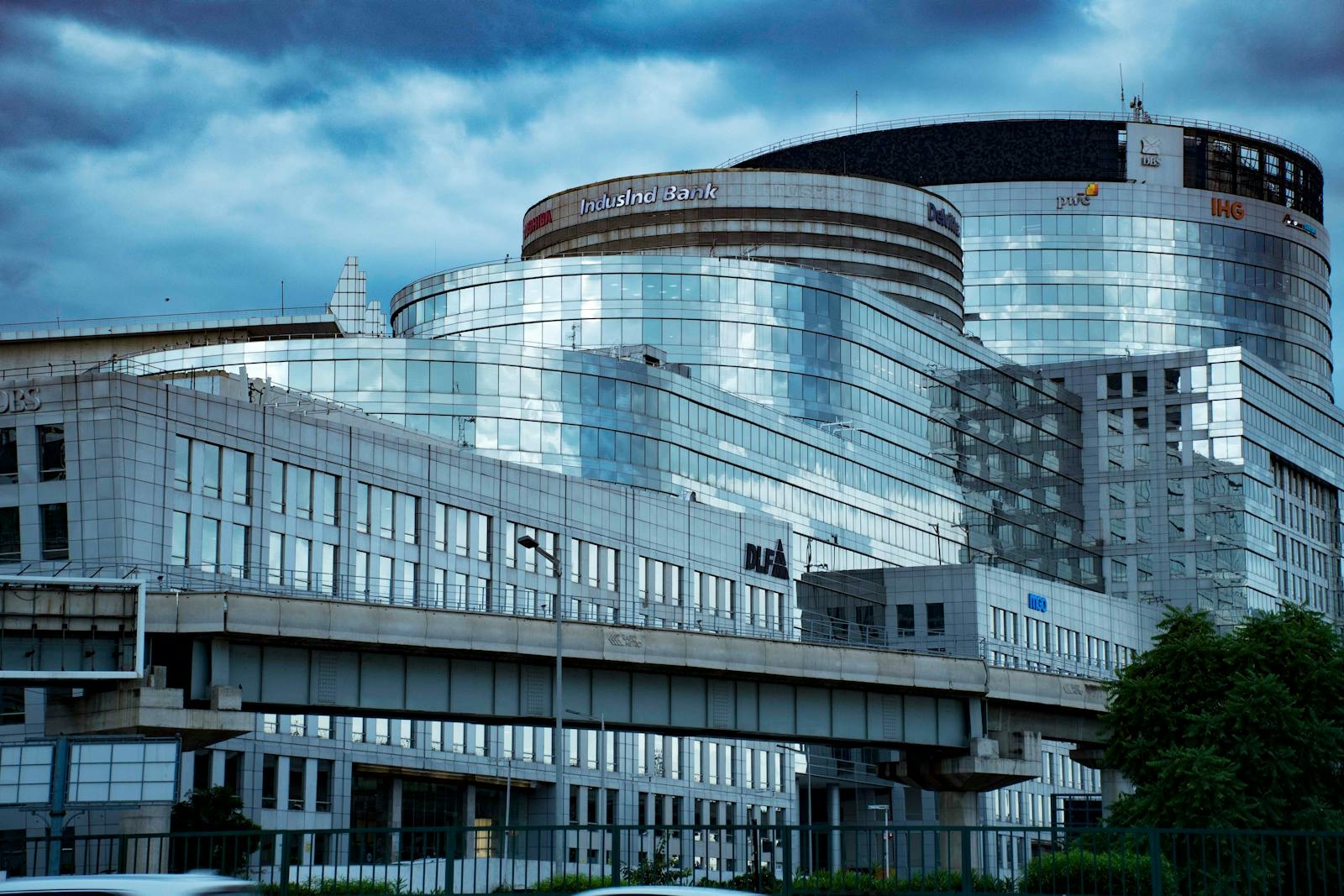A sleek modern glass banking building in an urban city setting, showcasing reflective architecture.