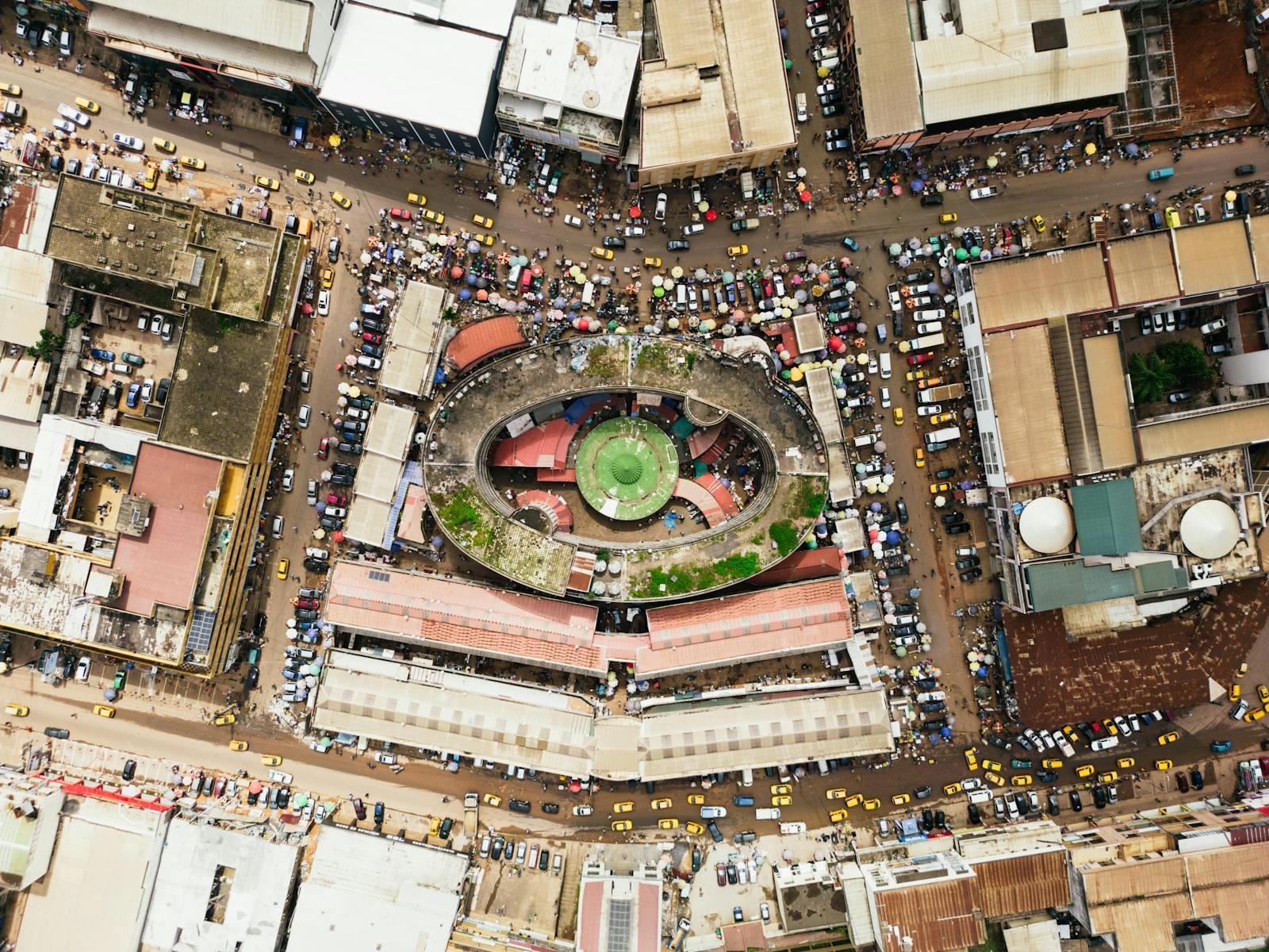 Aerial shot of bustling central market in Yaoundé, Cameroon showcasing busy streets and rooftops.