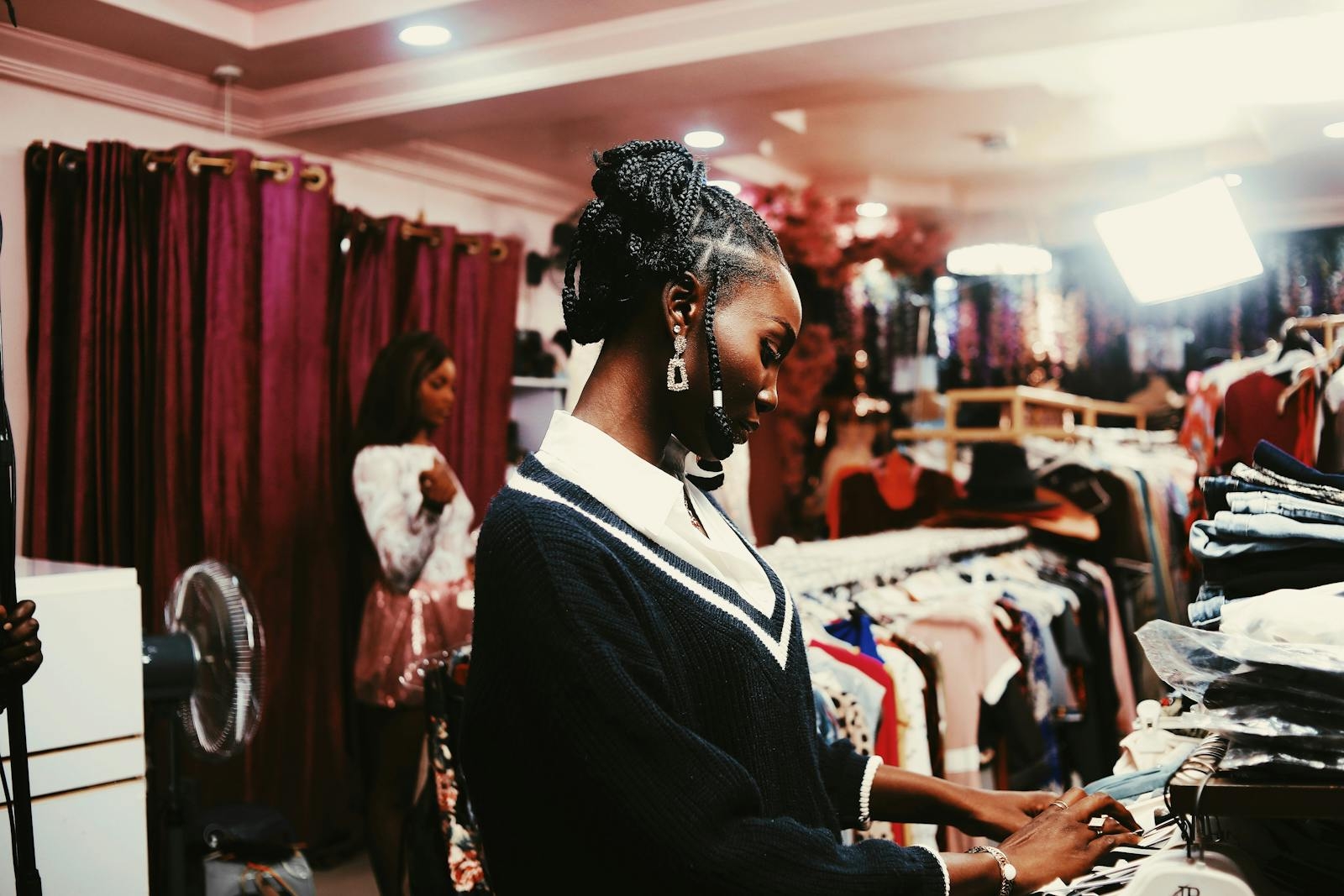 Two women shopping in stylish Abuja boutique. Fashion, elegance and modern trends.