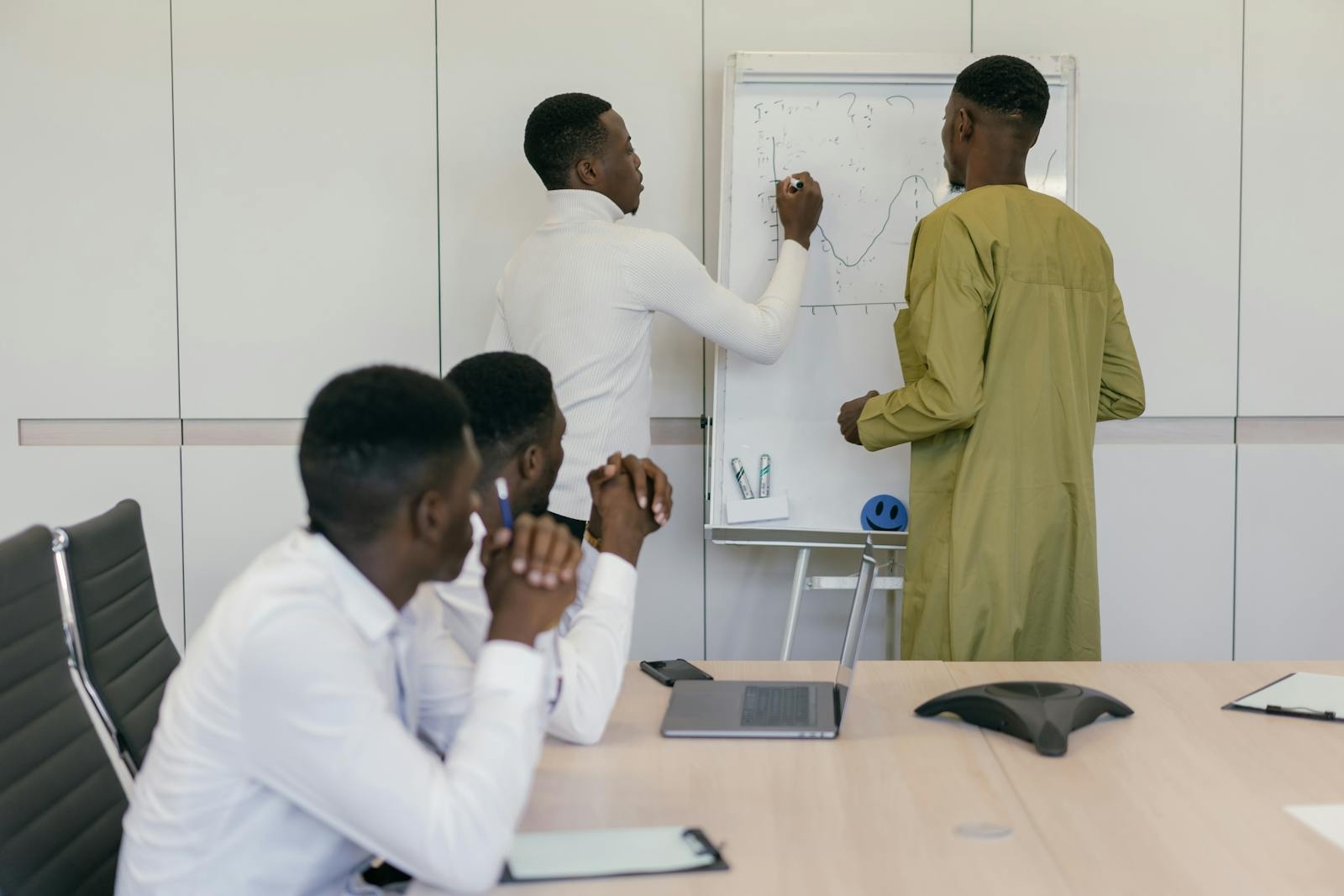 Business professionals brainstorming strategy in a modern office setting.