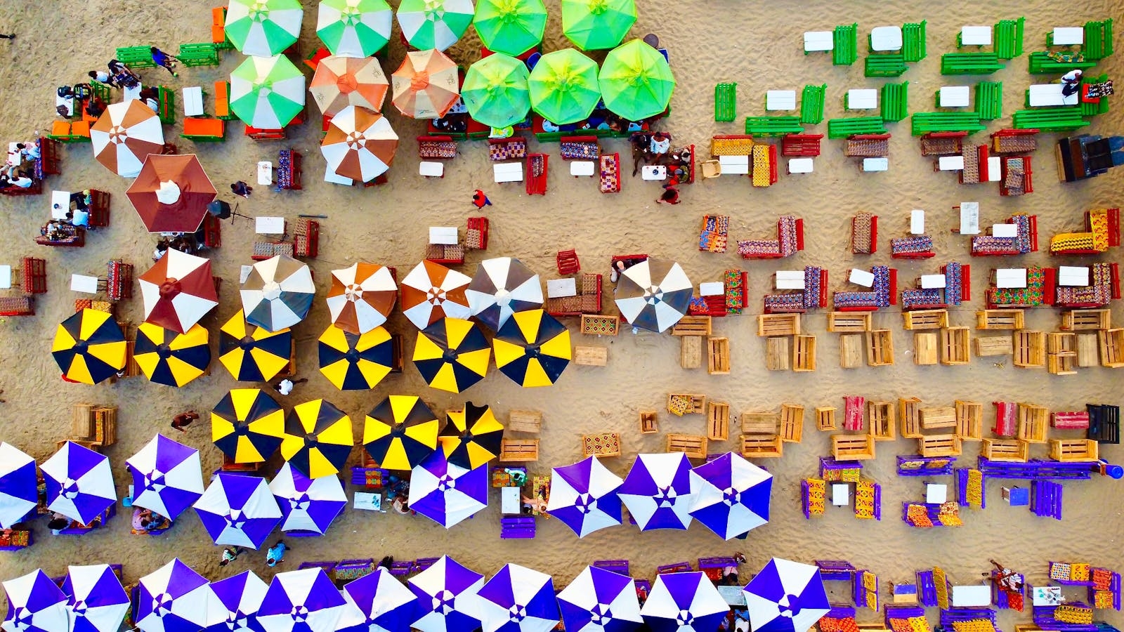 Vibrant aerial view of beach umbrellas and seating in Accra, Ghana.