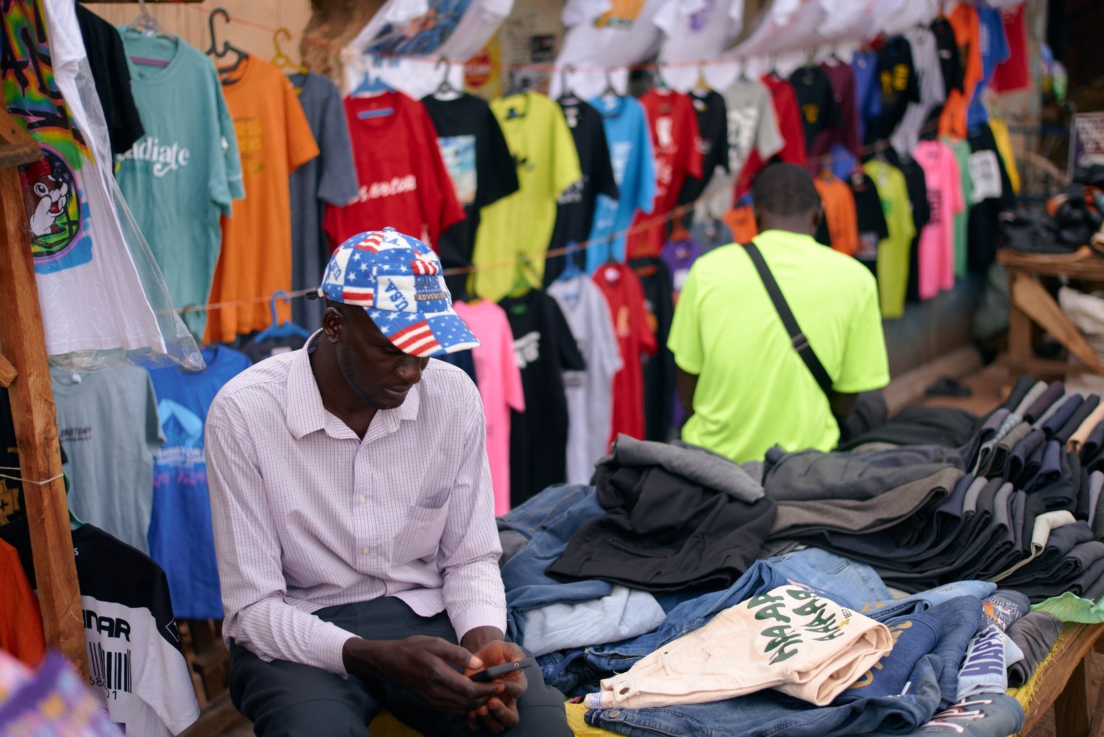 Explore the colorful evening market in Jos, Nigeria, featuring vibrant clothes and local sellers.