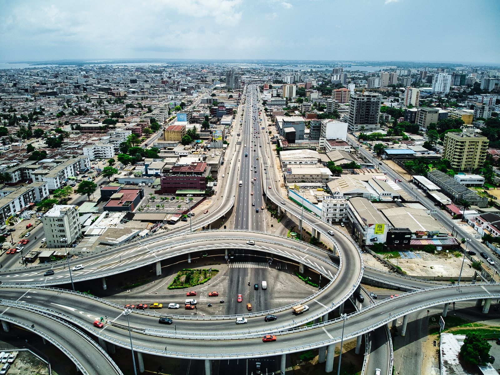 Dynamic aerial shot of Abidjan's expressway showcasing modern urban infrastructure and vibrant cityscape.